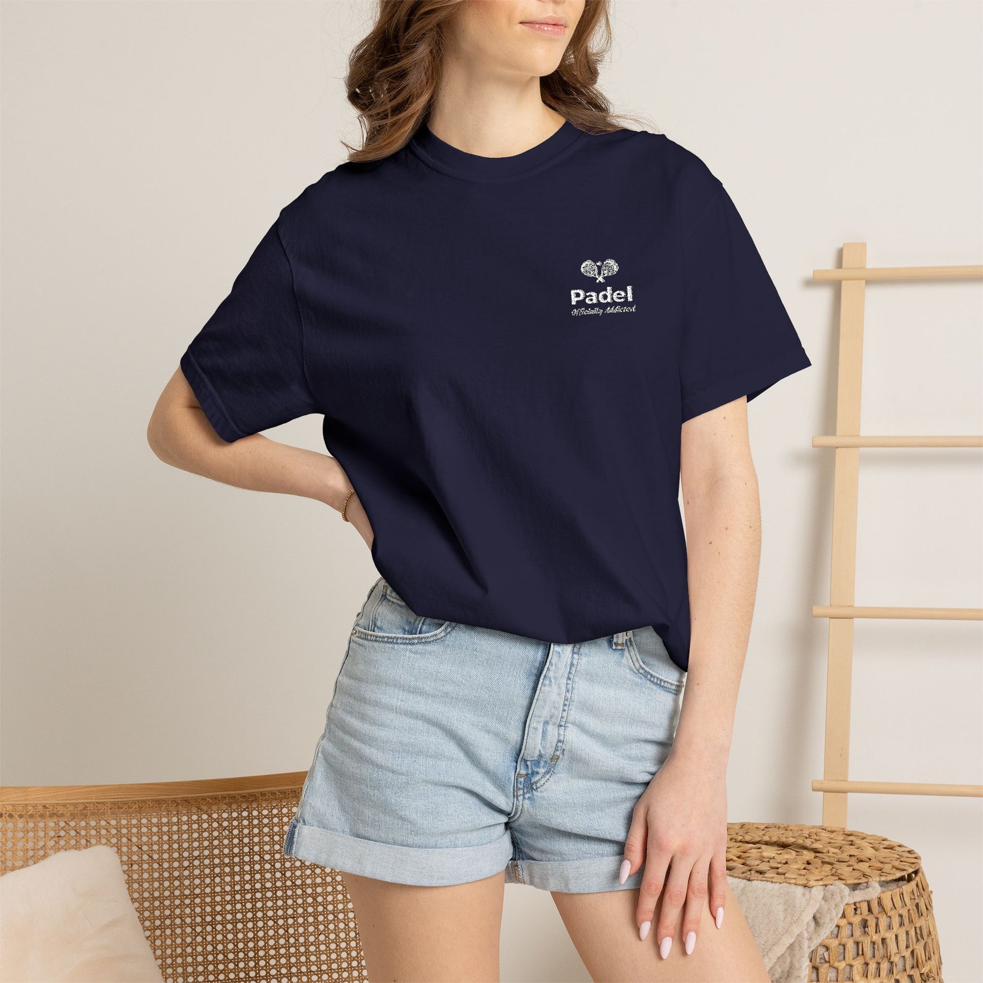 Officially Addicted Tee lifestyle shot — woman wearing navy padel tee — Rally Cove